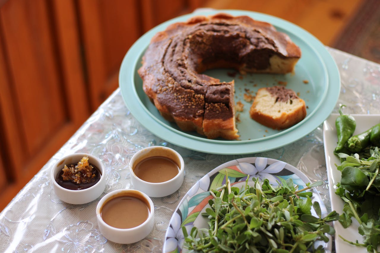 our-services-3 Delicious traditional Turkish breakfast with cake, sauces, and greens on a wooden table.