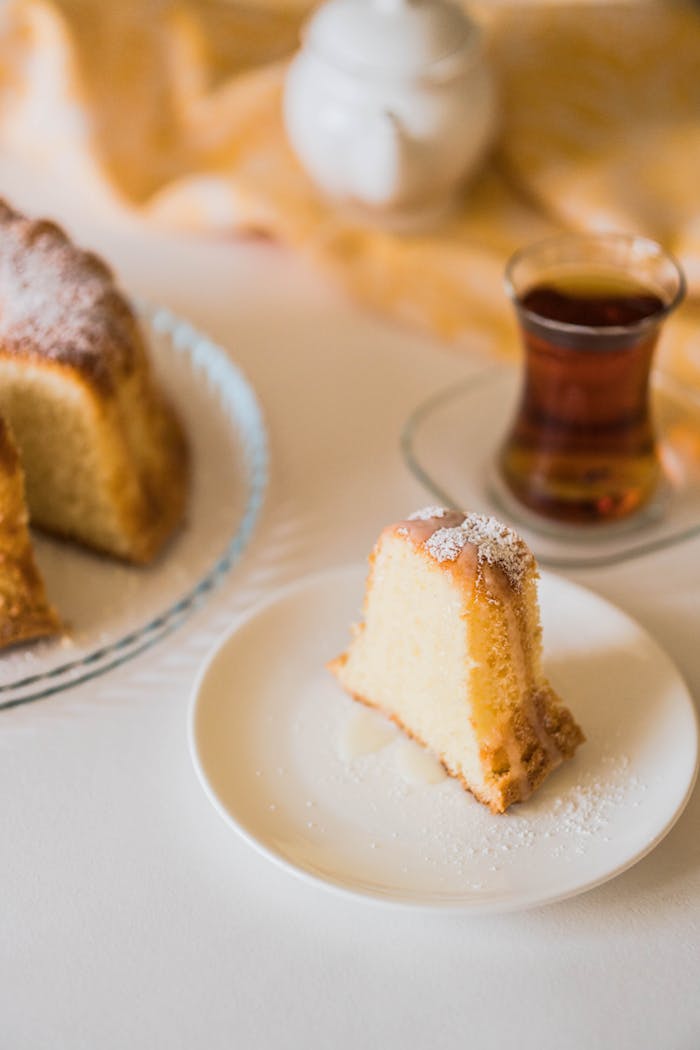 our-services-1 Fresh cake slice with traditional tea setting, showcasing Azerbaijani hospitality.